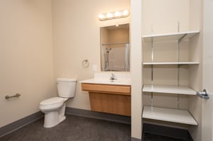 Bathroom with storage closet in a senior living apartment
