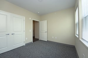 Bedroom with large closet in a senior living apartment at Scheper Ridge