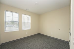 Bedroom with large windows in income based senior living community