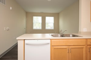 Kitchen & Living Room with view of dishwasher in affordable senior apartment at Scheper Ridge