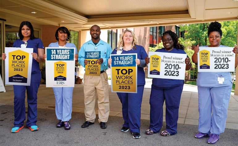 Team members at Marjorie P. Lee in Hyde Park celebrating the Top Workplaces win